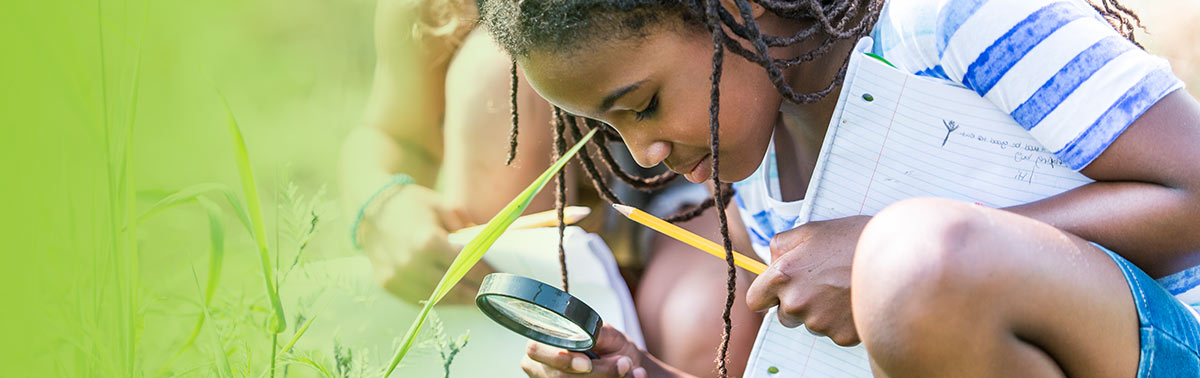 child with magnifying glass