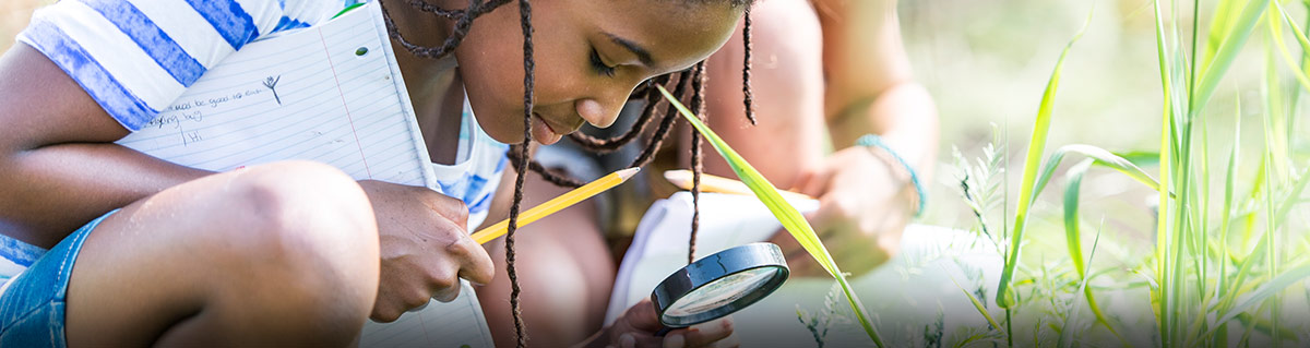 child with magnifying glass